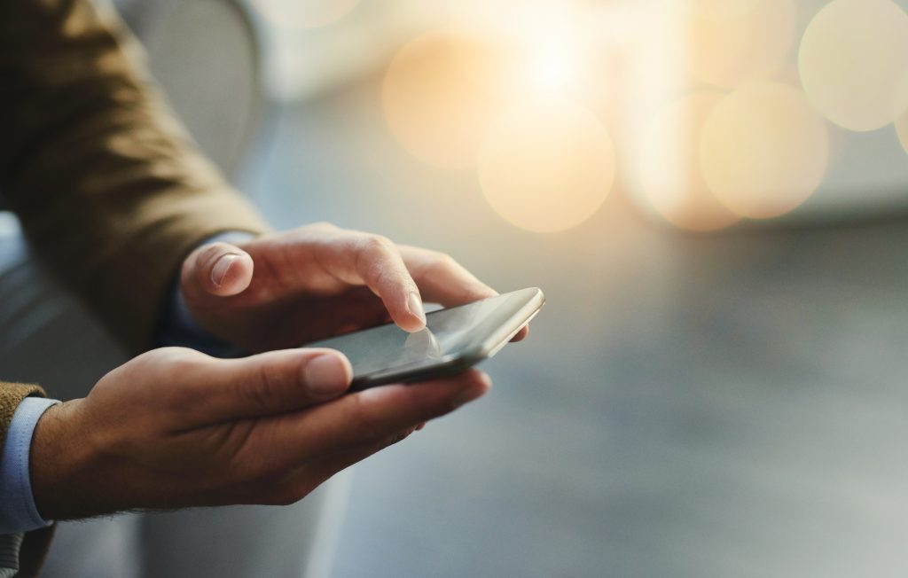 High angle shot of an unrecognizable businessman using a mobile phone